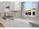Bright kitchen featuring a farmhouse sink, granite countertops, and stainless steel appliances at 13914 E Laurel Ln, Scottsdale, AZ 85259