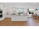 Bright, white kitchen with an island, stainless steel appliances, and hardwood floors at 13914 E Laurel Ln, Scottsdale, AZ 85259