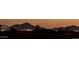 Silhouetted view of cityscape and mountains at night, lit with city lights at 13914 E Laurel Ln, Scottsdale, AZ 85259