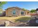 Well-maintained backyard with lush landscaping, and a tranquil pergola at 15272 W Georgia Dr, Surprise, AZ 85379