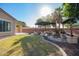 Lush backyard with green grass and a beautiful pergola, perfect for entertaining at 15272 W Georgia Dr, Surprise, AZ 85379
