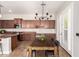 The dining area, features wood table and easy access to a fully equipped kitchen at 15272 W Georgia Dr, Surprise, AZ 85379