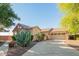 Beautiful single-story home with desert landscaping, a three-car garage, and a paver driveway at 15272 W Georgia Dr, Surprise, AZ 85379