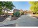Exterior view of a home with desert landscaping, a brick wall, and a paver driveway at 15272 W Georgia Dr, Surprise, AZ 85379