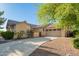 Charming home with a manicured lawn, mature trees, and a spacious driveway at 15272 W Georgia Dr, Surprise, AZ 85379