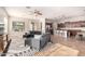 Open-concept living room with modern sectional, ceiling fan and access to the kitchen at 15272 W Georgia Dr, Surprise, AZ 85379