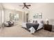 Bright main bedroom boasts a ceiling fan, windows, and serene atmosphere at 15272 W Georgia Dr, Surprise, AZ 85379