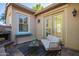 Cozy patio area with outdoor seating and a charming stone fireplace at 15272 W Georgia Dr, Surprise, AZ 85379