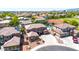 Aerial view captures the home with a tile roof and community amenities like a pool and tennis courts nearby at 15725 W Yucatan Dr, Surprise, AZ 85379