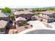 Aerial view highlighting the home with a desert landscape and proximity to a neighboring pool and fenced yards at 15725 W Yucatan Dr, Surprise, AZ 85379