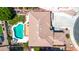 Top-down aerial view displaying a house with a pool, backyard garden, patio furniture, and green outdoor space at 15725 W Yucatan Dr, Surprise, AZ 85379