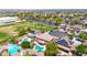 Expansive aerial view showcasing lush landscaping, sparkling pool, and solar panels in a vibrant community at 15725 W Yucatan Dr, Surprise, AZ 85379