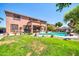 Spacious backyard featuring a private pool, well-maintained lawn, and lush greenery at 15725 W Yucatan Dr, Surprise, AZ 85379