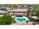 Aerial shot of a private backyard featuring a beautiful pool, lush greenery, and outdoor entertaining space at 15725 W Yucatan Dr, Surprise, AZ 85379