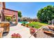 Spacious backyard featuring a well-maintained lawn, a sparkling pool, and a cozy patio area at 15725 W Yucatan Dr, Surprise, AZ 85379
