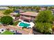 Aerial view of a home with a covered patio and a sparkling swimming pool, perfect for outdoor living at 15725 W Yucatan Dr, Surprise, AZ 85379