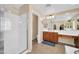 Well-lit bathroom with a glass shower and double sink vanity at 15725 W Yucatan Dr, Surprise, AZ 85379