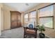 Cozy bedroom corner with accent chair, armoire and natural light at 15725 W Yucatan Dr, Surprise, AZ 85379