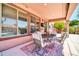 Cozy covered patio with comfortable seating, perfect for outdoor relaxation and enjoying the pool view at 15725 W Yucatan Dr, Surprise, AZ 85379