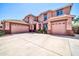 Attractive two-story home featuring a three-car garage and a well-manicured front yard at 15725 W Yucatan Dr, Surprise, AZ 85379