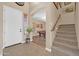 Welcoming foyer with stairs, tiled flooring, and an arched entryway with a view of the billiard room at 15725 W Yucatan Dr, Surprise, AZ 85379
