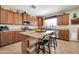 A well-appointed kitchen with stainless appliances, lots of cabinet space, stone countertops, and island seating at 15725 W Yucatan Dr, Surprise, AZ 85379