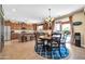 A spacious kitchen with a dining table and chairs, stainless steel appliances, ample cabinetry, and access to the backyard pool at 15725 W Yucatan Dr, Surprise, AZ 85379