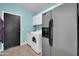 Well lit Laundry Room featuring a washer, dryer, and refrigerator at 15725 W Yucatan Dr, Surprise, AZ 85379
