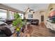 Cozy living room with hardwood floors, a leather sofa, and natural light from large windows at 15725 W Yucatan Dr, Surprise, AZ 85379