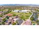 Aerial shot of the neighborhood showcasing the property near community spaces with views of mountains in the background at 15725 W Yucatan Dr, Surprise, AZ 85379
