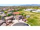 Panoramic aerial view capturing the house in a neighborhood near fields, mountains, and community buildings at 15725 W Yucatan Dr, Surprise, AZ 85379