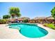 Refreshing swimming pool surrounded by lush landscaping and a well-maintained patio for outdoor enjoyment at 15725 W Yucatan Dr, Surprise, AZ 85379