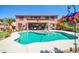 Backyard pool with view of the house and patio at 15725 W Yucatan Dr, Surprise, AZ 85379