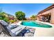 Relaxing poolside view with lounge chairs and a well-manicured garden providing a serene setting at 15725 W Yucatan Dr, Surprise, AZ 85379
