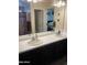 Bathroom featuring double sinks, a large mirror, and modern fixtures at 15939 W Post Dr, Surprise, AZ 85374