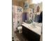 Bathroom with vanity, mirror, and tub featuring a playful nautical themed shower curtain at 15939 W Post Dr, Surprise, AZ 85374