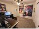 Spacious bedroom with ceiling fan, plush carpet, and cool posters at 15939 W Post Dr, Surprise, AZ 85374