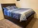 Simple bedroom with a comfortable bed and carpeted floors at 15939 W Post Dr, Surprise, AZ 85374