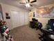 Bedroom with carpet flooring, ceiling fan, and closet with sliding doors at 15939 W Post Dr, Surprise, AZ 85374