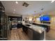 Spacious kitchen featuring stainless steel appliances, granite countertops, and wood flooring at 15939 W Post Dr, Surprise, AZ 85374