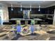 A modern kitchen with dark cabinetry, a stainless steel refrigerator, and marble countertops on the kitchen island at 15939 W Post Dr, Surprise, AZ 85374