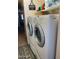Modern laundry room with front loading washer and dryer at 15939 W Post Dr, Surprise, AZ 85374