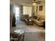 Cozy living room with neutral tones, comfortable seating, and a large area rug at 15939 W Post Dr, Surprise, AZ 85374
