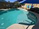 Refreshing pool with a tanning ledge, framed by tropical decor and a playful backdrop for outdoor enjoyment at 15939 W Post Dr, Surprise, AZ 85374