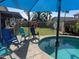 Inviting backyard pool area with comfortable lounge chairs and lush landscaping, perfect for relaxation and outdoor fun at 15939 W Post Dr, Surprise, AZ 85374