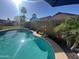Beautiful pool area surrounded by lush landscaping, offering a serene escape in this private backyard retreat at 15939 W Post Dr, Surprise, AZ 85374