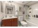 A clean bathroom with sink, toilet, and bathtub/shower combination and lots of counter space at 1618 N 32Nd St # 5, Phoenix, AZ 85008