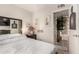 Bedroom features comfortable bed, plants, decorative artwork, and bright airy atmosphere at 1618 N 32Nd St # 5, Phoenix, AZ 85008