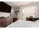 Bedroom with a comfortable bed, sliding glass door with balcony, and entertainment center at 1618 N 32Nd St # 5, Phoenix, AZ 85008