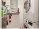 Modern laundry room with a stackable washer and dryer, shelving, and fire extinguisher at 1618 N 32Nd St # 5, Phoenix, AZ 85008